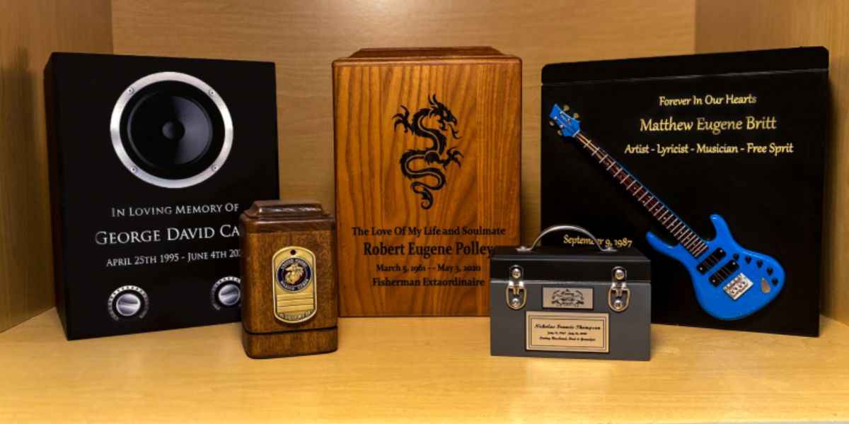 5 customized cremation urns grouped on a shelf.