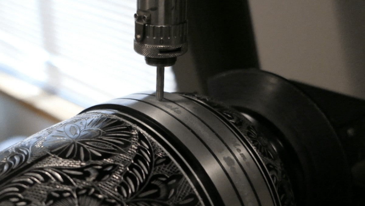Engraving a metal cremation urn.