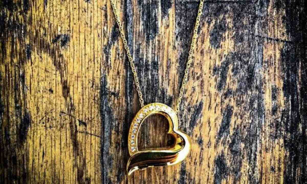 Gold heart cremation jewelry pendant.