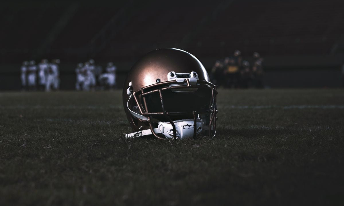 Football helmet resting on the football field.