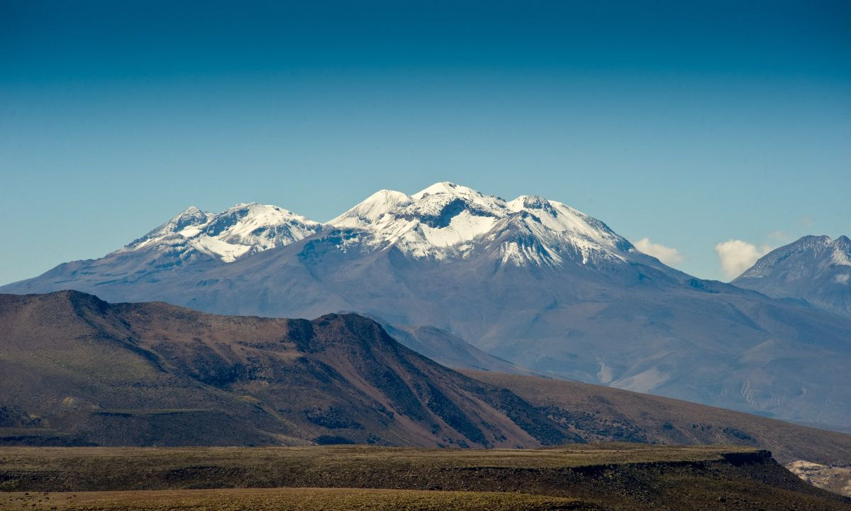 Large mountain in the distance with snowy peaks.