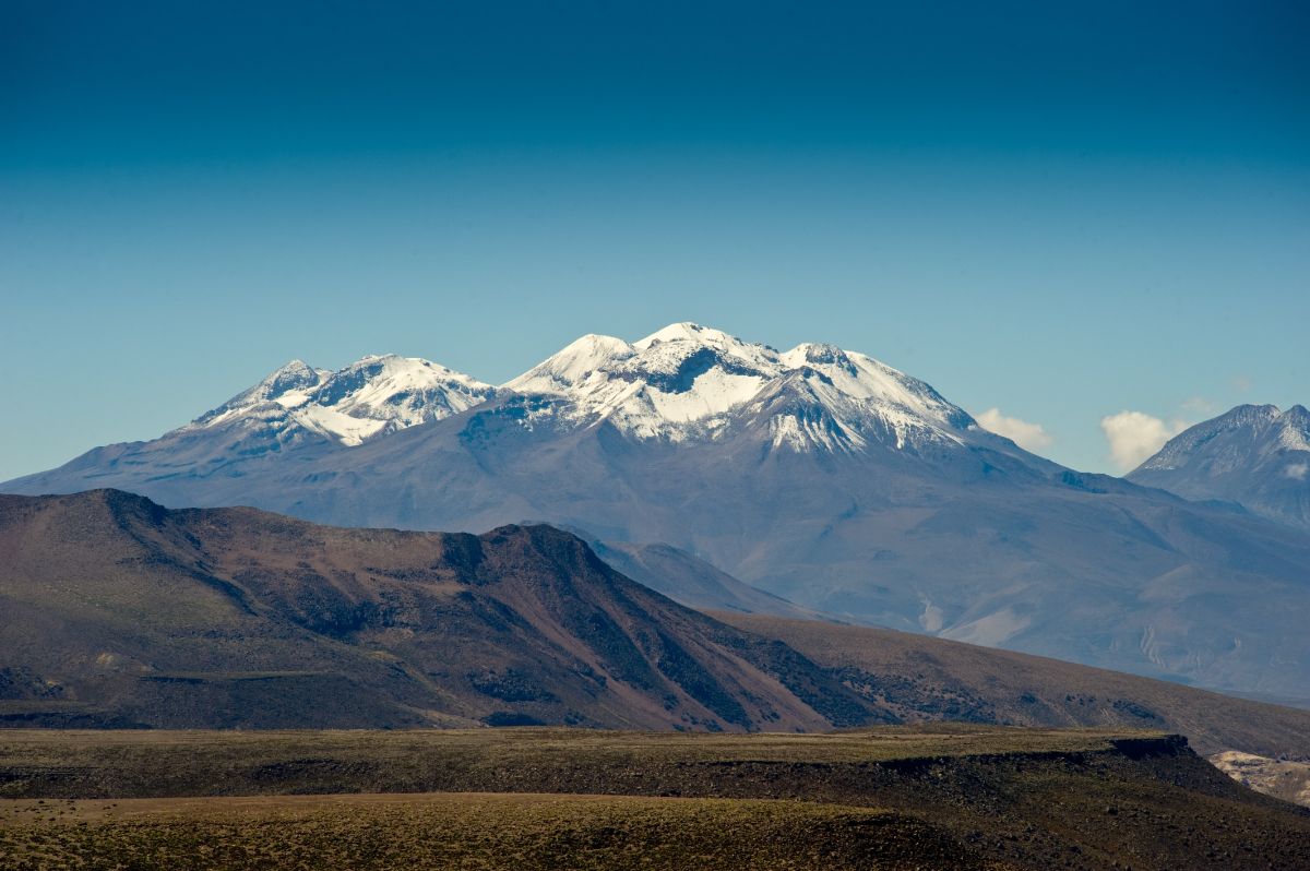 Large mountain in the distance with snowy peaks.