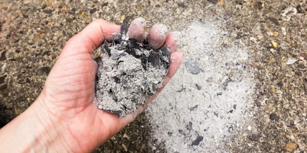 Cremation ashes resting in the palm of a hand.